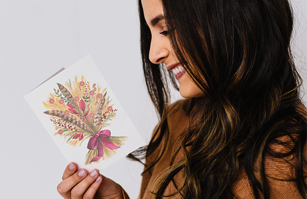 Woman holding thanksgiving card